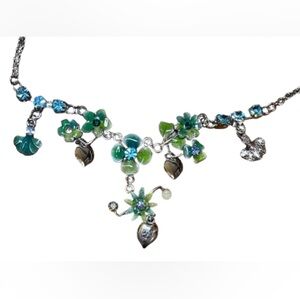 Whimsical flower necklace with blue and green stones and silver tone chain